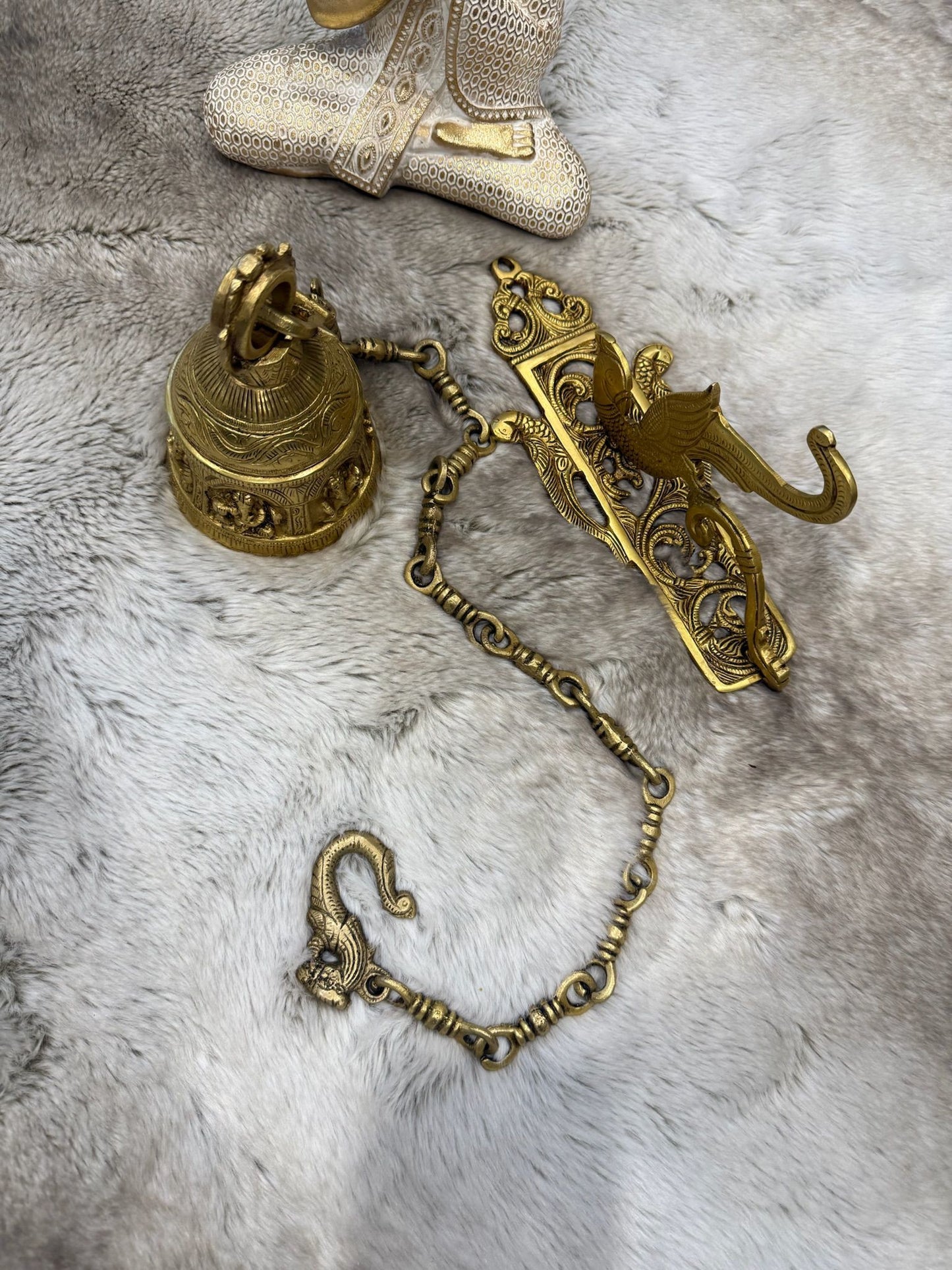 Brass Temple bell engraved with Ganesha in musical avatars having peacock hooks