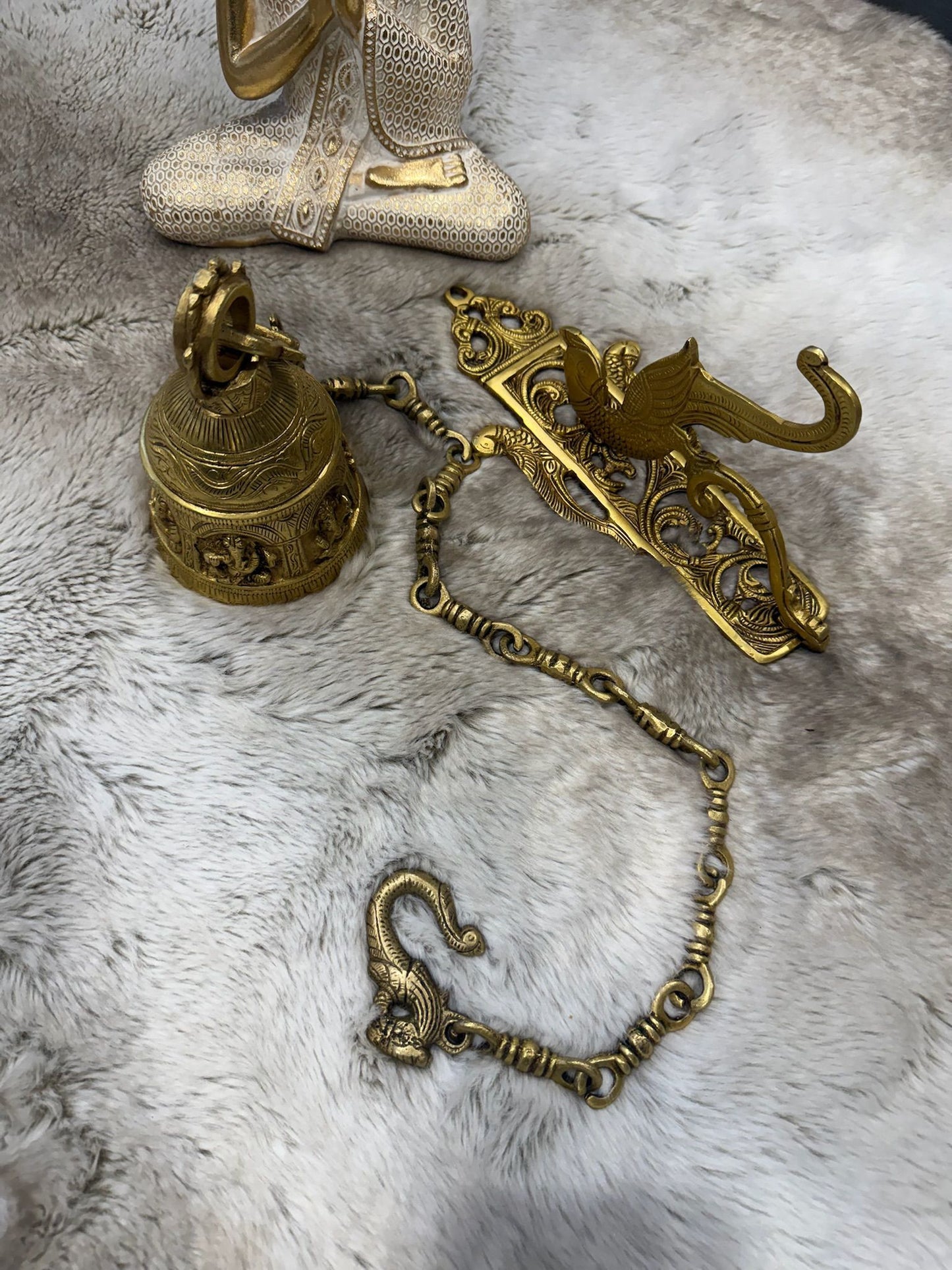 Brass Temple bell engraved with Ganesha in musical avatars having peacock hooks