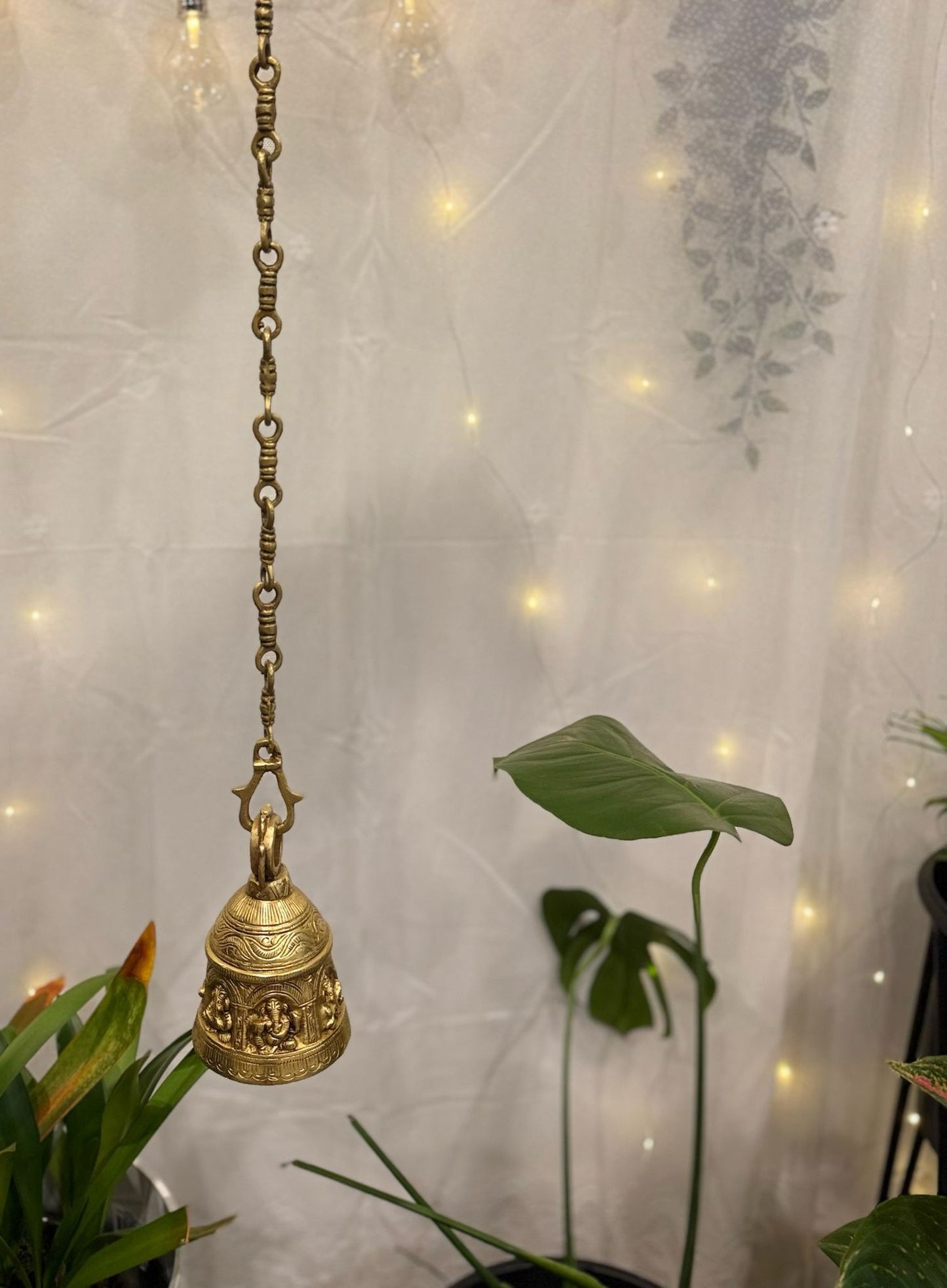 Brass Temple bell engraved with Ganesha in musical avatars having peacock hooks