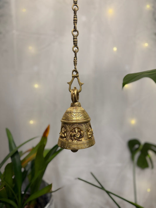 Brass Temple bell engraved with Ganesha in musical avatars having peacock hooks