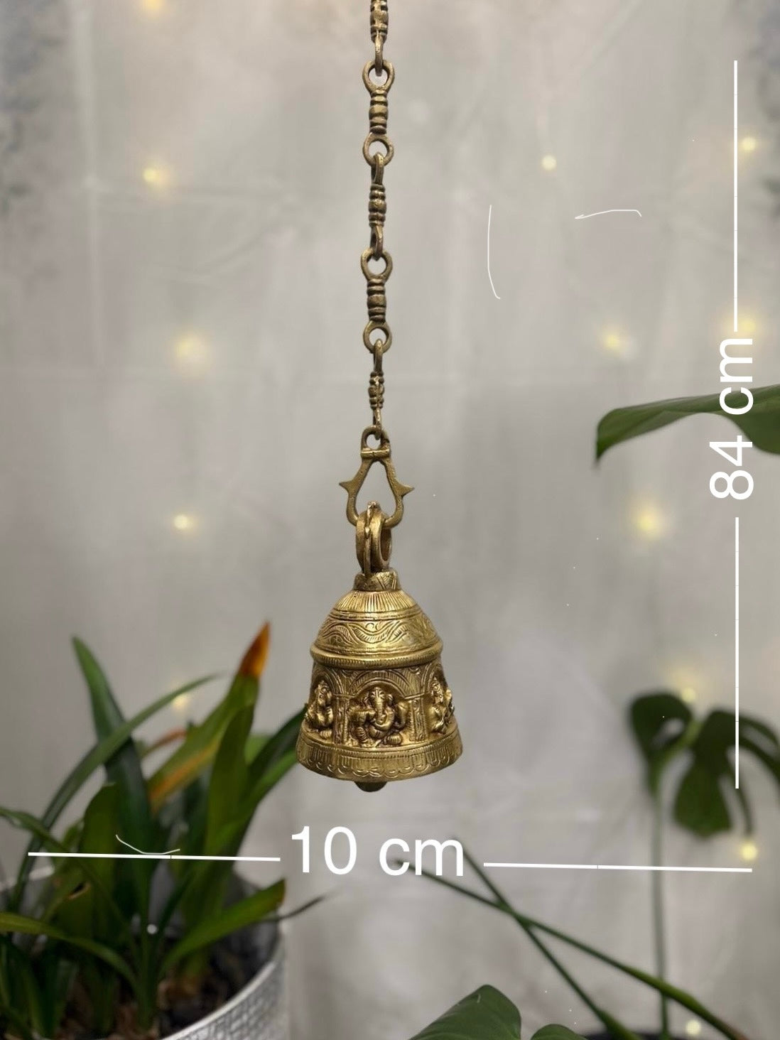Brass Temple bell engraved with Ganesha in musical avatars having peacock hooks