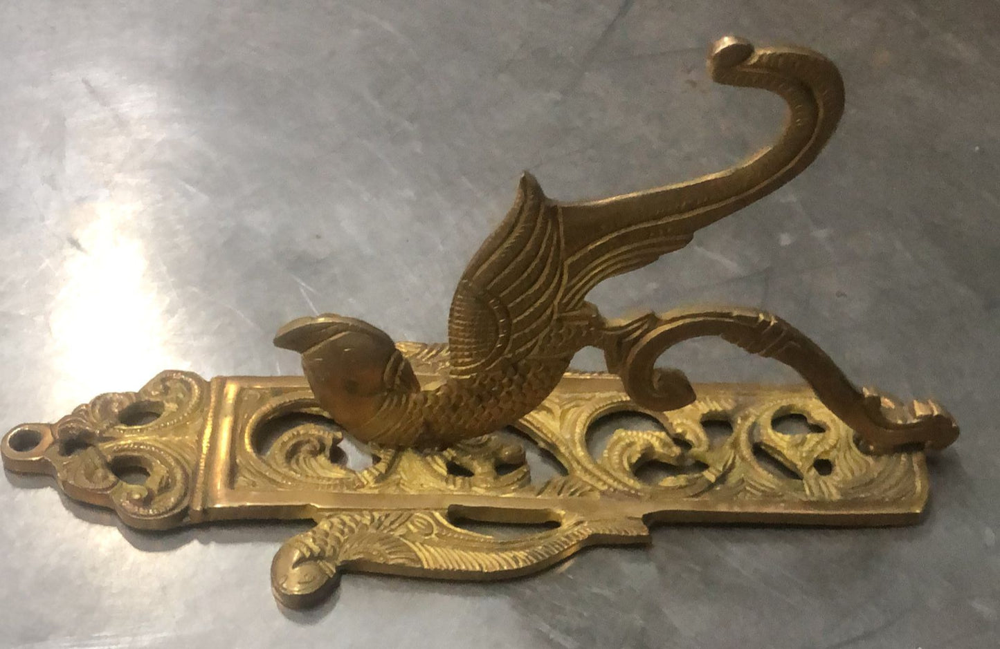 Brass Temple bell engraved with Ganesha in musical avatars having peacock hooks