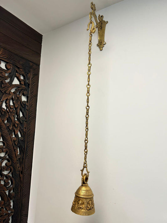 Brass Temple bell engraved with Ganesha in musical avatars having peacock hooks