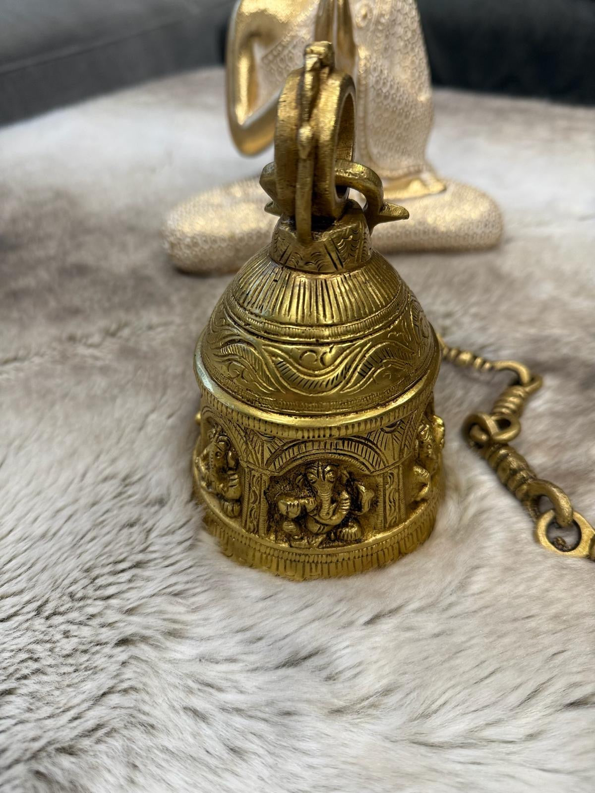 Brass Temple bell engraved with Ganesha in musical avatars having peacock hooks